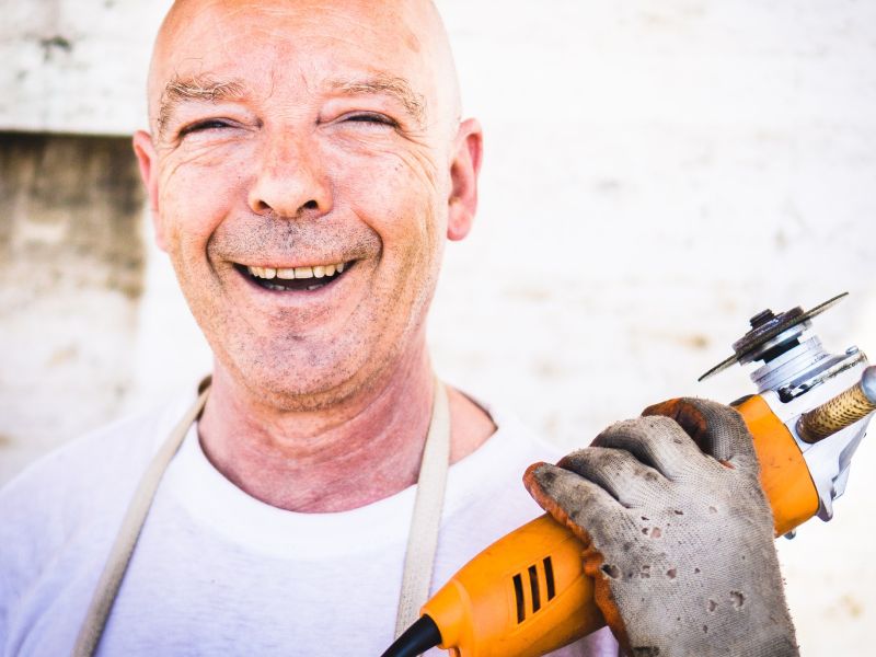 Laughing craftsman with Flex as a symbol for business model innovation Tool sharing - TOM SPIKE