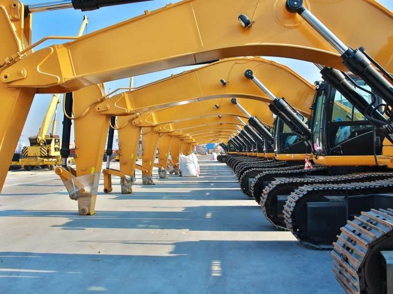 Parked yellow excavator as a symbol for utilization management in construction - TOM SPIKE